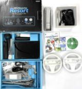 A boxed Nintendo Wii Sports Resort Pak, with console, sensor, power pack, 2 steering wheels, 2