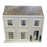 A modern wooden scratchbuilt dolls house, unfurnished. Size approximately 55cm wide x 54cm high.