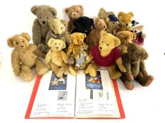 A quantity of various older and modern teddy bears of various sizes, together with a folder