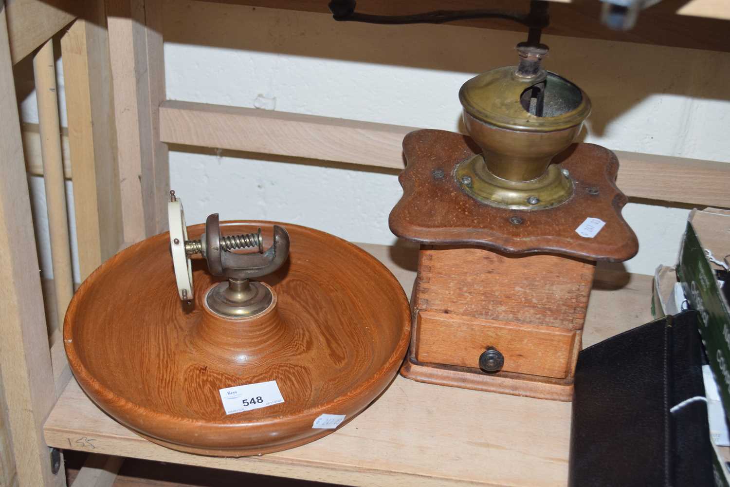 Vintage coffee grinder and a vintage nut cracker on turned wooden base