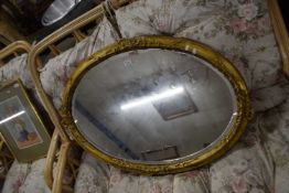 19th Century oval bevelled wall mirror in gilt finish frame with ribbon decoration