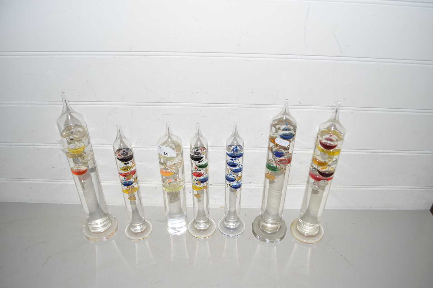 Collection of seven glass Galileo type thermometers