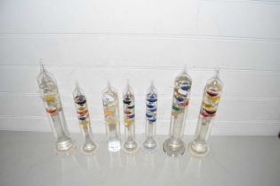 Collection of seven glass Galileo type thermometers
