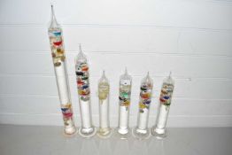 Six various glass Galileo thermometers