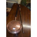 Copper bed warming pan and a walking stick