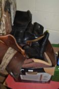 Two pairs of riding boots and a saddle