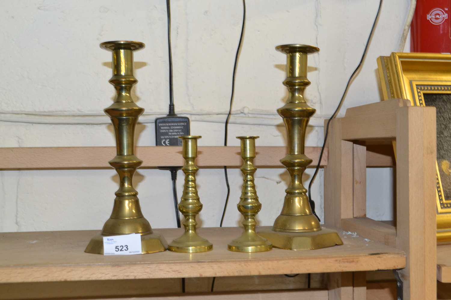 Two pairs of brass candlesticks