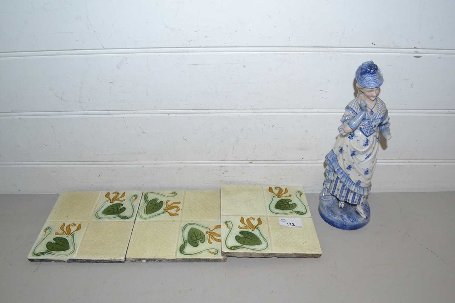 Three late Victorian floral decorated tiles and a blue and white figure (a/f)