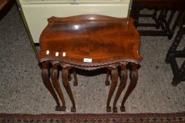 Nest of three mahogany veneered coffee tables on cabriole legs