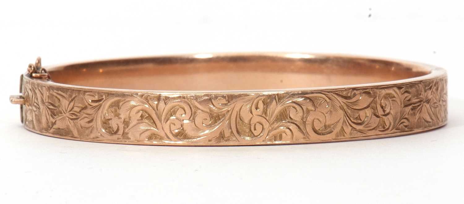 9ct hinged bracelet, the top section chased and engraved with a foliate design, hallmarked for