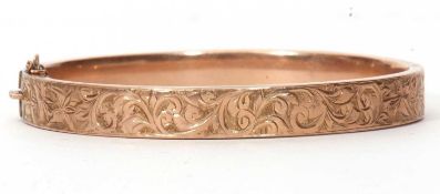 9ct hinged bracelet, the top section chased and engraved with a foliate design, hallmarked for
