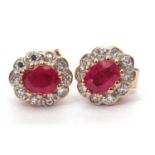A pair of modern small ruby and diamond cluster earrings with post fittings and tested for 9ct gold