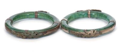 Mixed Lot: Two Chinese green glass bangles applied with metal dragon design