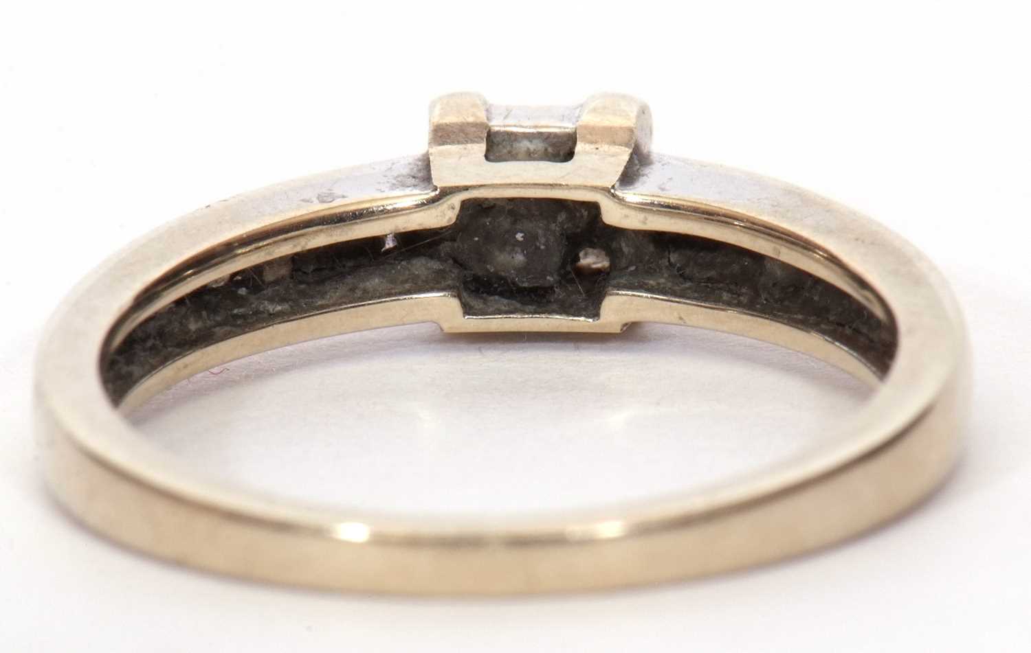A modern diamond set ring, the square panel set with four small princess cut diamonds and raised - Image 4 of 9