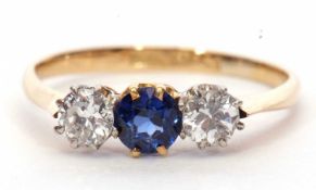 Sapphire and diamond three stone ring, the round faceted sapphire is flanked by two round