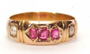 An antique ruby and seed pearl ring centering three graduated rubies between two small seed