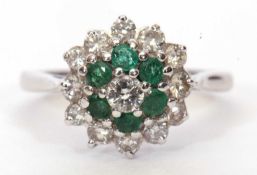 Modern 18ct gold emerald and diamond cluster ring centering a round brilliant cut diamond 0.15ct