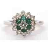 Modern 18ct gold emerald and diamond cluster ring centering a round brilliant cut diamond 0.15ct