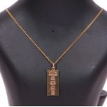 9ct gold pendant with oversized hallmarks for Birmingham 1977 suspended from a 9ct stamped chain,