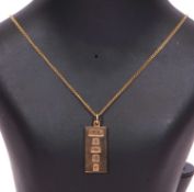 9ct gold pendant with oversized hallmarks for Birmingham 1977 suspended from a 9ct stamped chain,