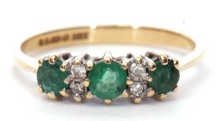 9ct gold emerald and diamond ring, the design featuring three small round cut emeralds highlighted