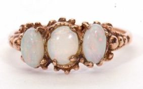 Modern 9ct gold three stone opalescent ring featuring three oval cabochon opalescents in a carved