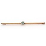 Vintage aquamarine brooch centering a round faceted aquamarine on a plain polished bar, stamped 9ct,