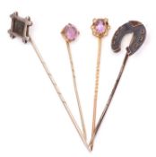Group of four stick pins to include amethyst and seed pearl cluster finial, a horseshoe example