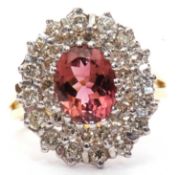 18ct gold pink tourmaline and diamond cluster ring centering an oval fasceted pink tourmaline, 1.