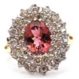 18ct gold pink tourmaline and diamond cluster ring centering an oval fasceted pink tourmaline, 1.