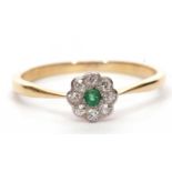 Small emerald and diamond cluster ring, a flower head design centering a round cut emerald within