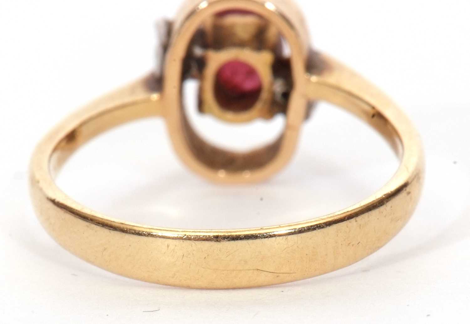 Modern ruby and diamond ring, the oval faceted ruby in an oval halo surround highlighted with two - Image 5 of 9