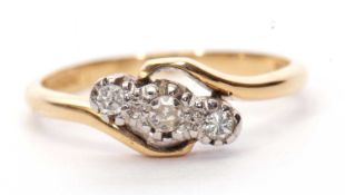 A three stone diamond crossover ring featuring three small single cut diamonds in illusion