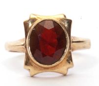 9ct gold garnet set ring, the oval faceted garnet is 10 x 8 mm bezel set in a shaped box mount,