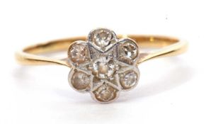 Diamond cluster ring, the flower head set with seven small single cut diamonds, stamped 18ct and