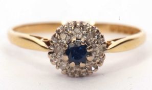 18ct gold sapphire and diamond cluster ring, the small round cut sapphire is raised above a small
