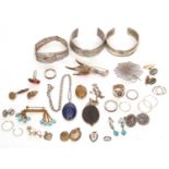 Mixed lot to include two metal torque bracelets, a Wedgwood pendant, a spiders web brooch, a