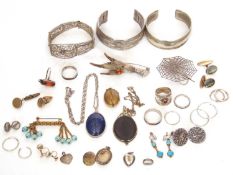 Mixed lot to include two metal torque bracelets, a Wedgwood pendant, a spiders web brooch, a