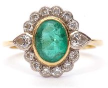 18ct gold emerald and diamond cluster ring, the bezel set oval emerald set within a pear and round