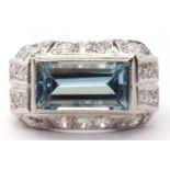 Art Deco oblong light blue stone ring in cut down setting and raised above a diamond mount set