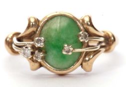 9ct gold jade and diamond ring, the oval cabochon shaped jade panel is bezel set with overlapping