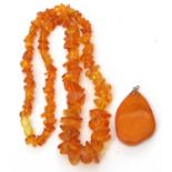 Modern amber pendant and a amber fragment necklace, g/w 38.5 gms