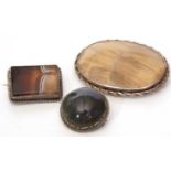 Three agate brooches, a large oval example, a rectangular banded agate brooch together with a