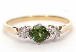 18ct gold green tourmaline and diamond three stone ring, the round cut tourmaline flanked by two