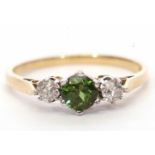 18ct gold green tourmaline and diamond three stone ring, the round cut tourmaline flanked by two