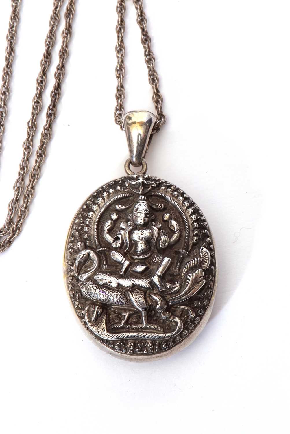 Large Indian white metal oval locket, the front elaborately decorated with a figure seated upon a - Image 3 of 5