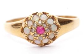 Late Victorian opal, ruby and diamond cluster ring centering a round cut ruby raised above a small