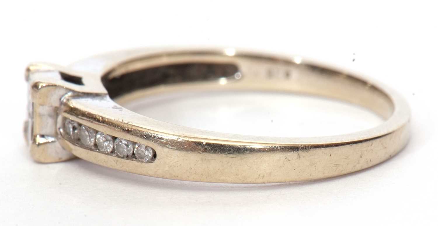 A modern diamond set ring, the square panel set with four small princess cut diamonds and raised - Image 3 of 9