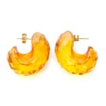 Pair of modern faceted amber earrings, a scroll design with post fittings