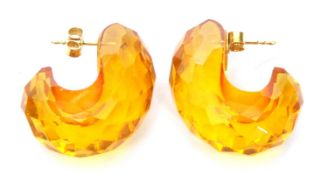 Pair of modern faceted amber earrings, a scroll design with post fittings